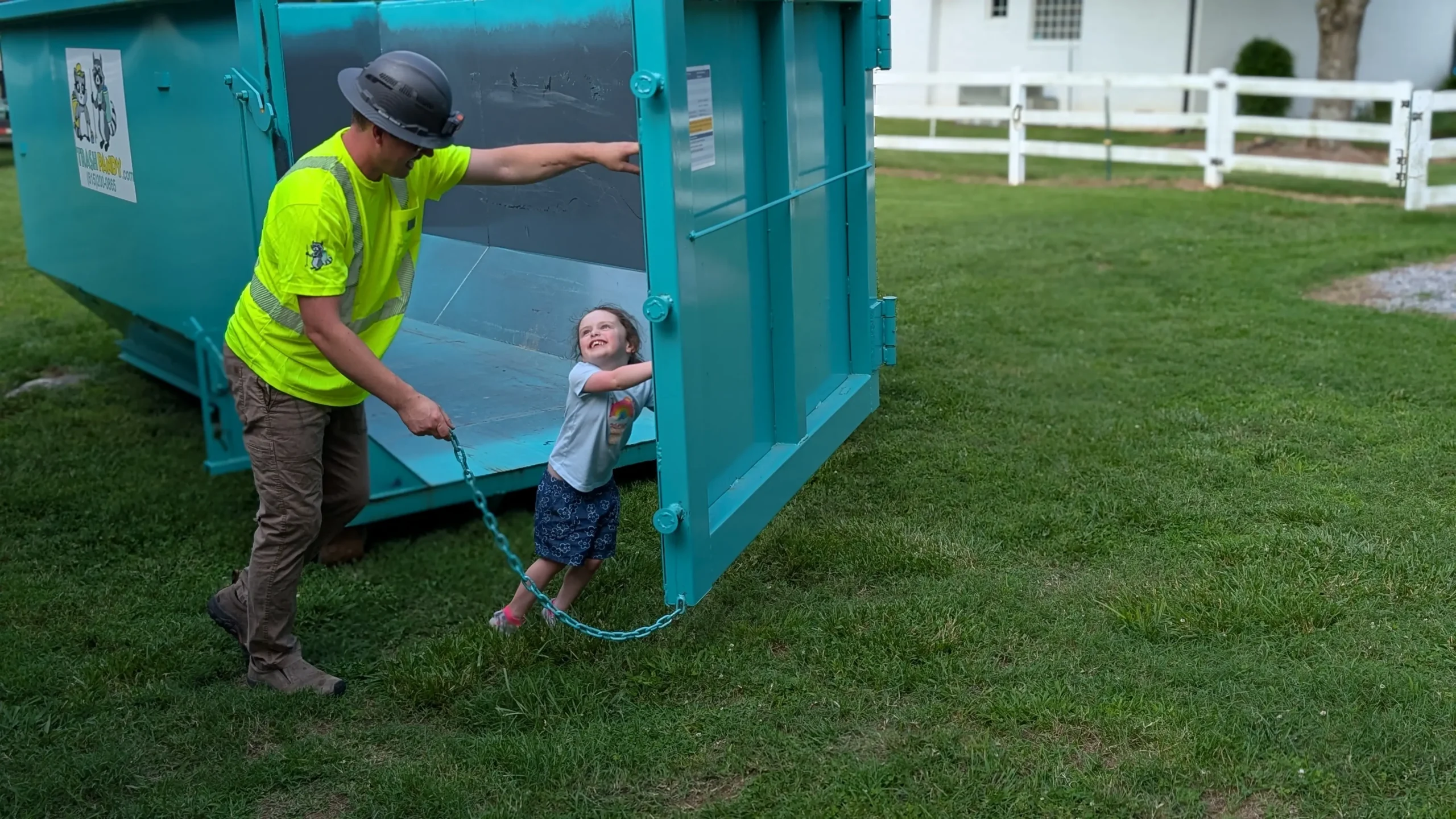 William Shackelford opening the doors on a Trash Pandy dumpster with his daughter